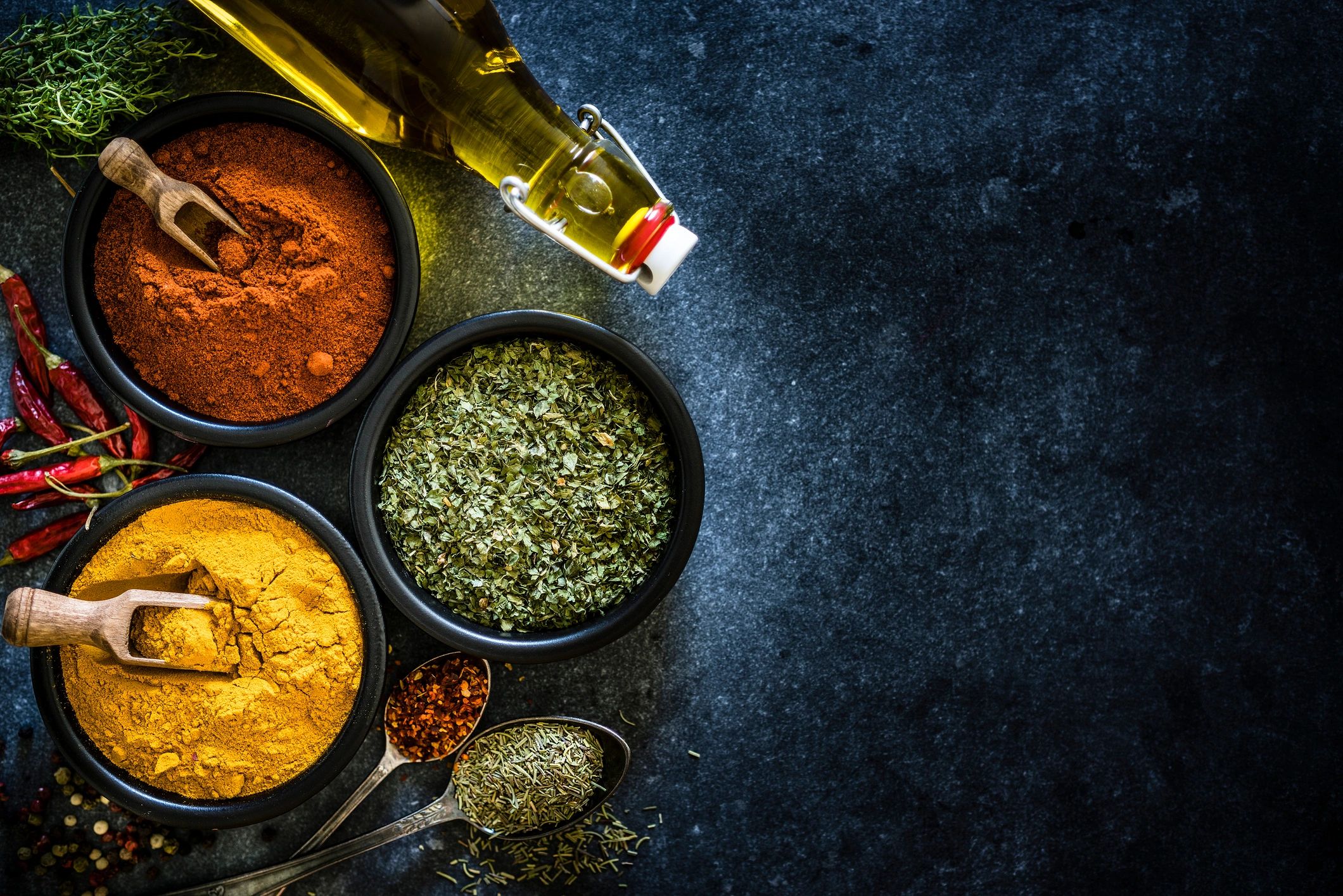 Bowls of turmeric, chili powder, and herbs