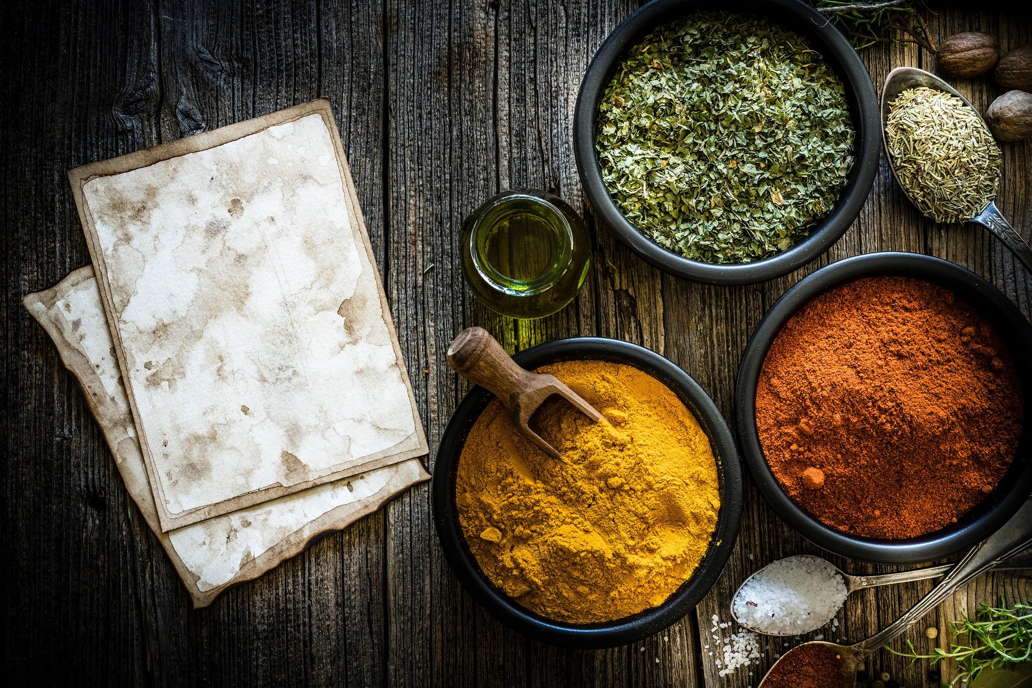 Indian spices in bowls on a dark wooden table