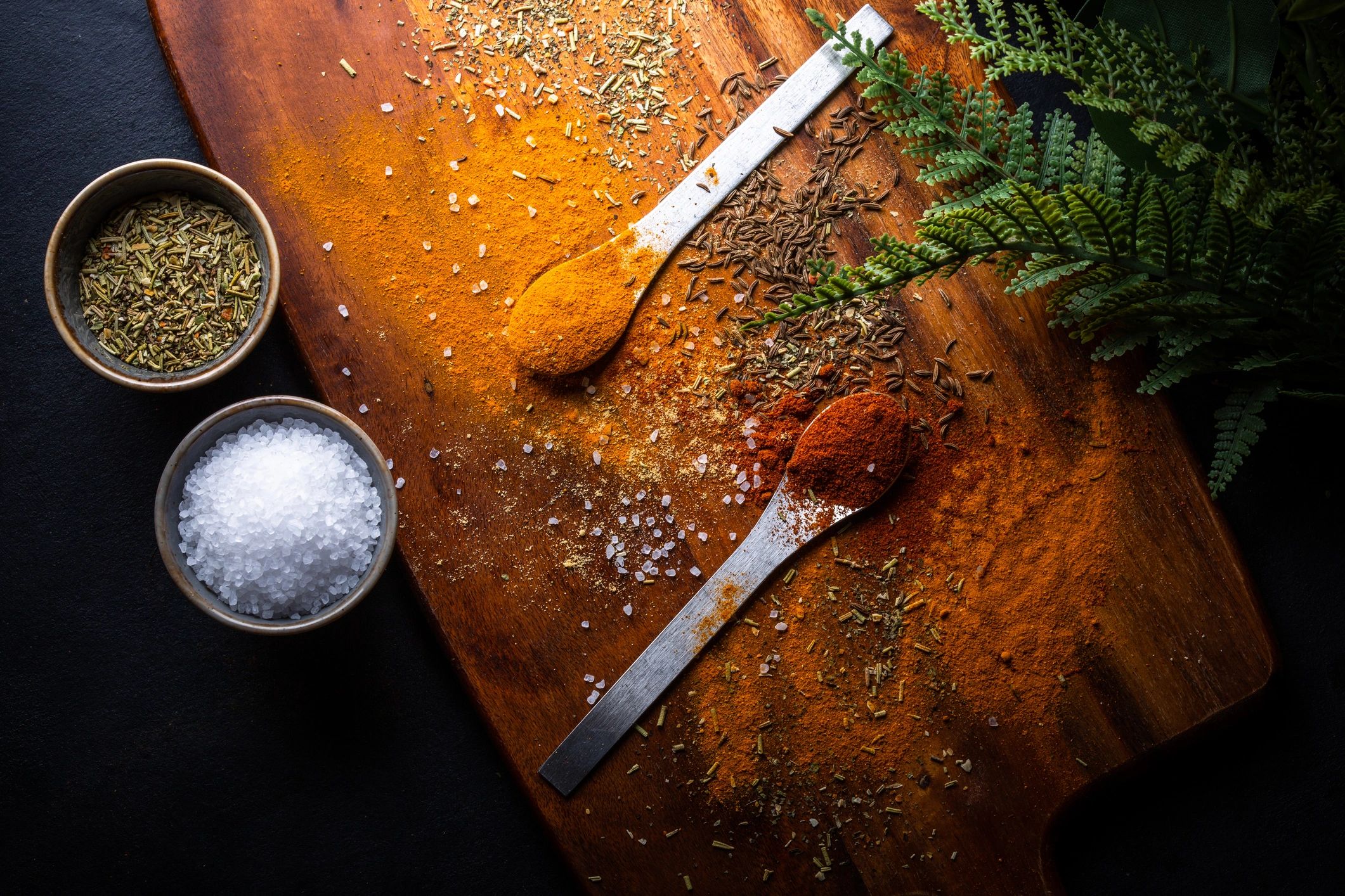Assorted spices on spoons and board