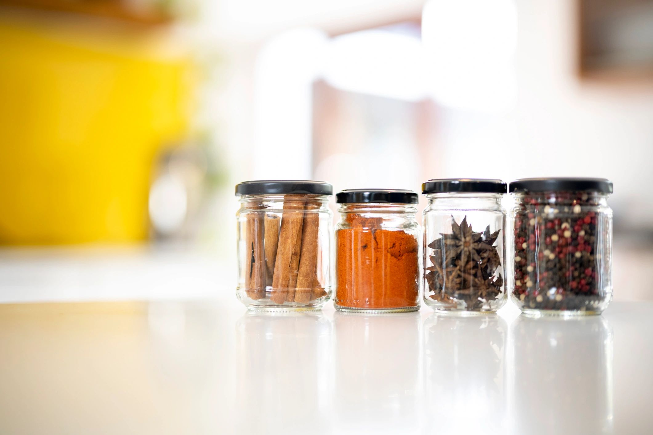 Spices stored in glass jars on a kitchen counter