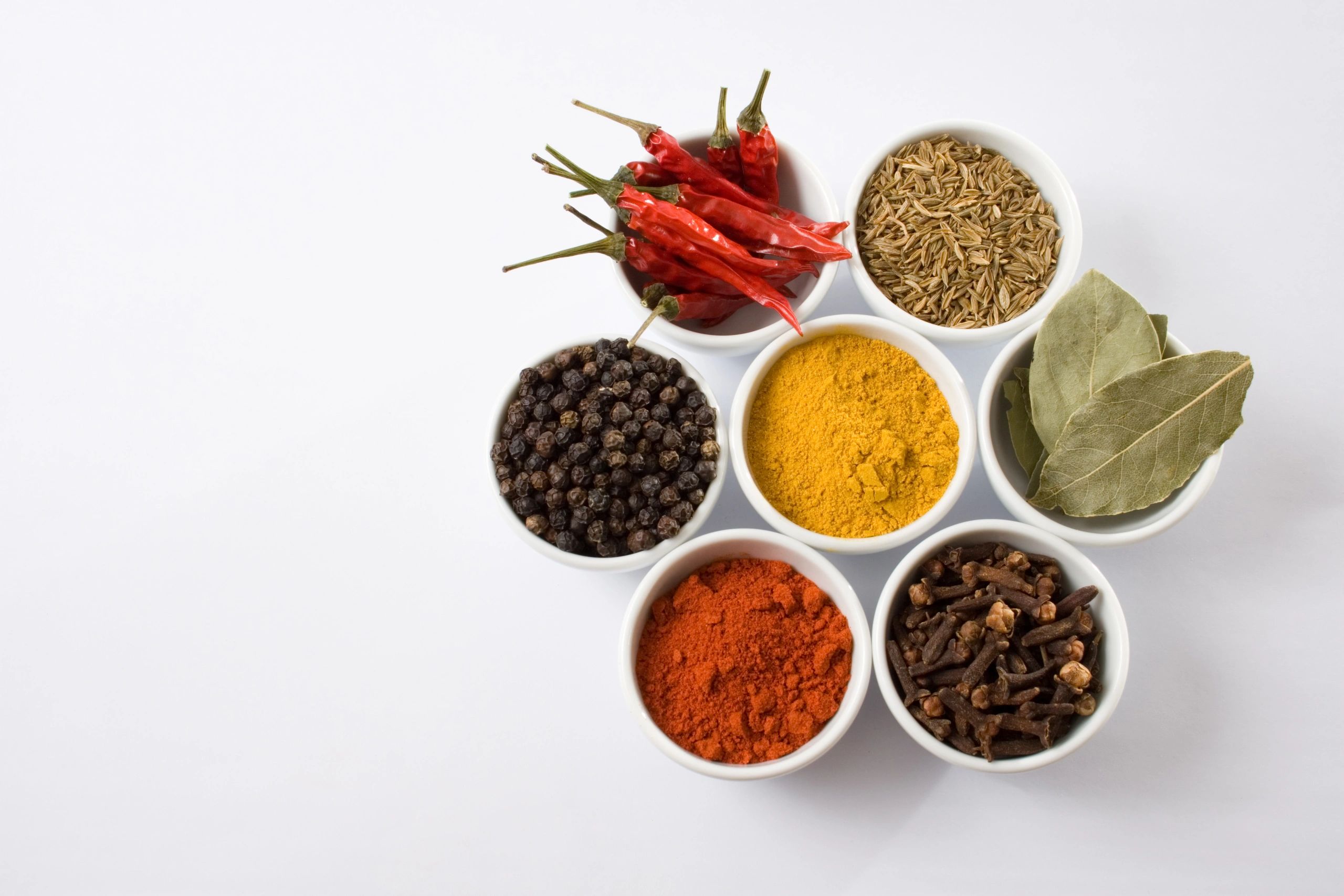 Assorted spices in small bowls for recipe inspiration