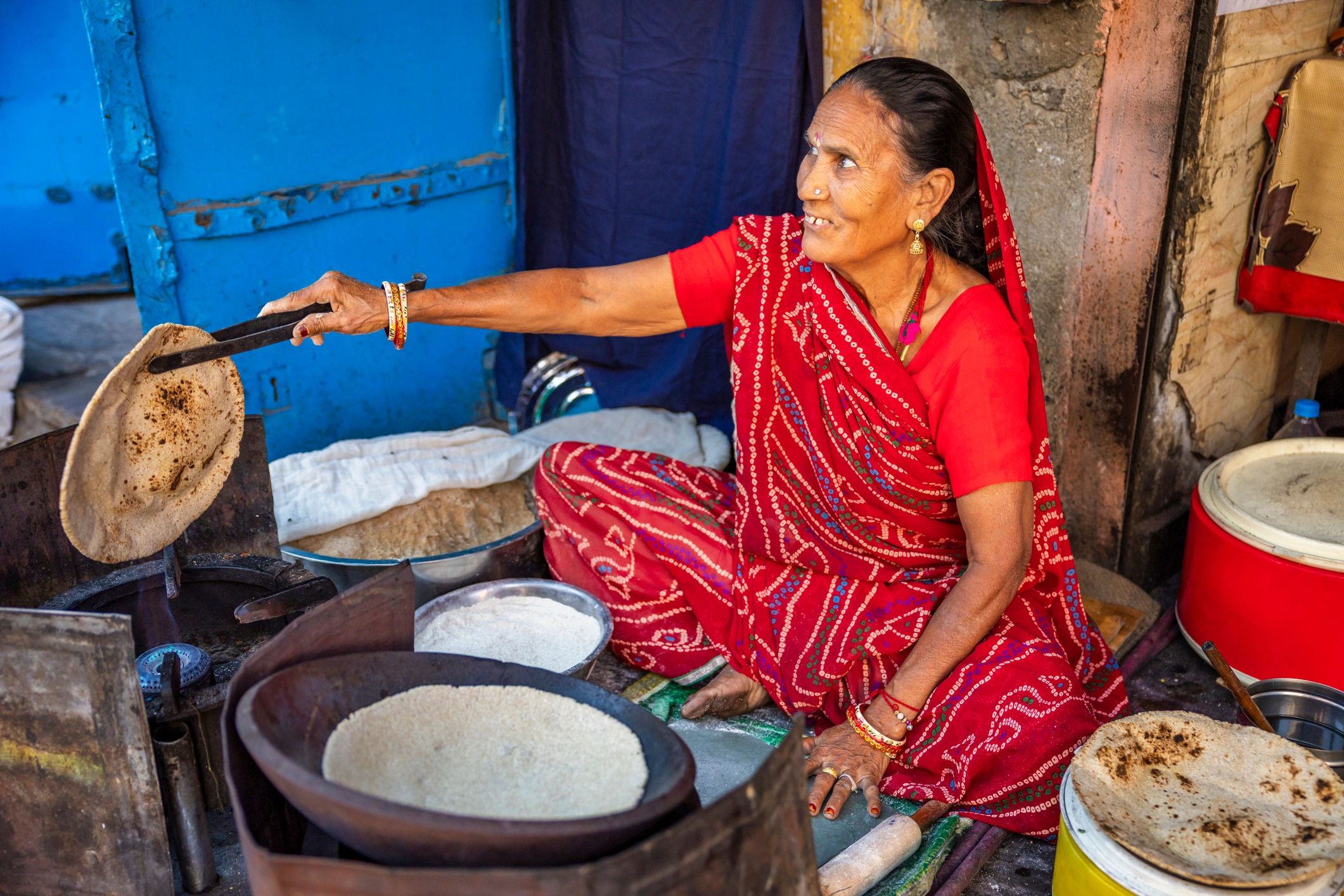 Team member involved in traditional food preparation